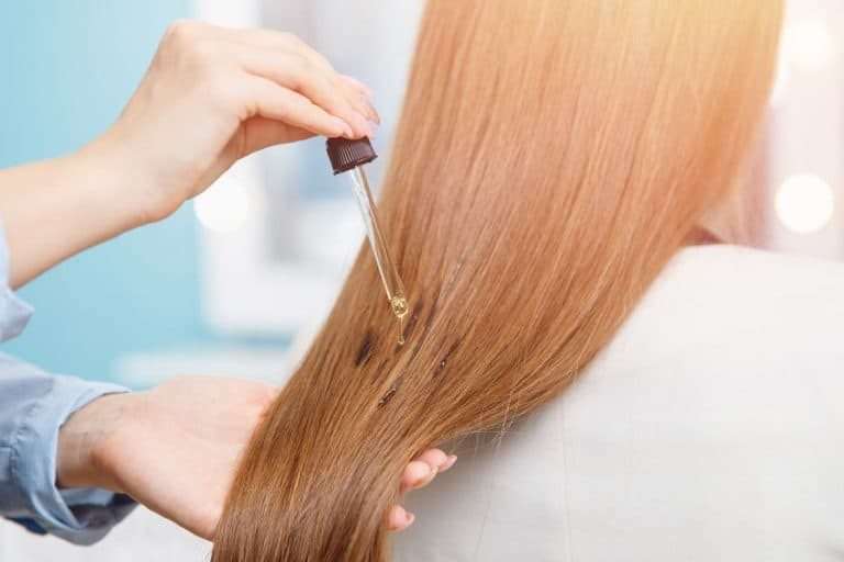 applying some castor oil on hair 